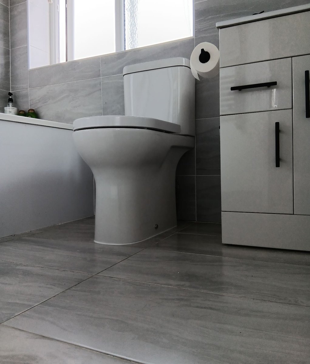 Grey bathroom with a new toilet and vanity unit