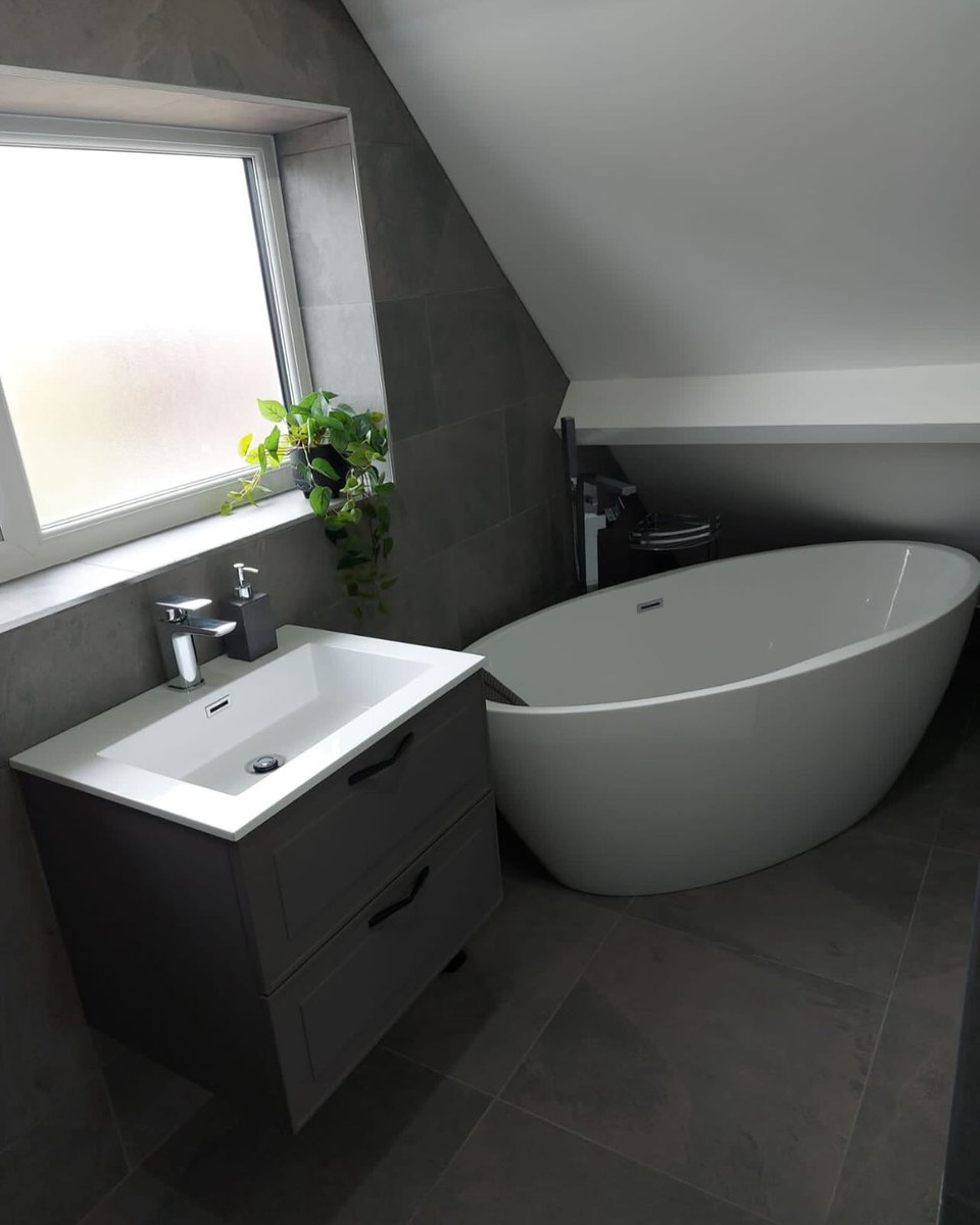 Loft bathroom with a freestanding bath and vanity unit