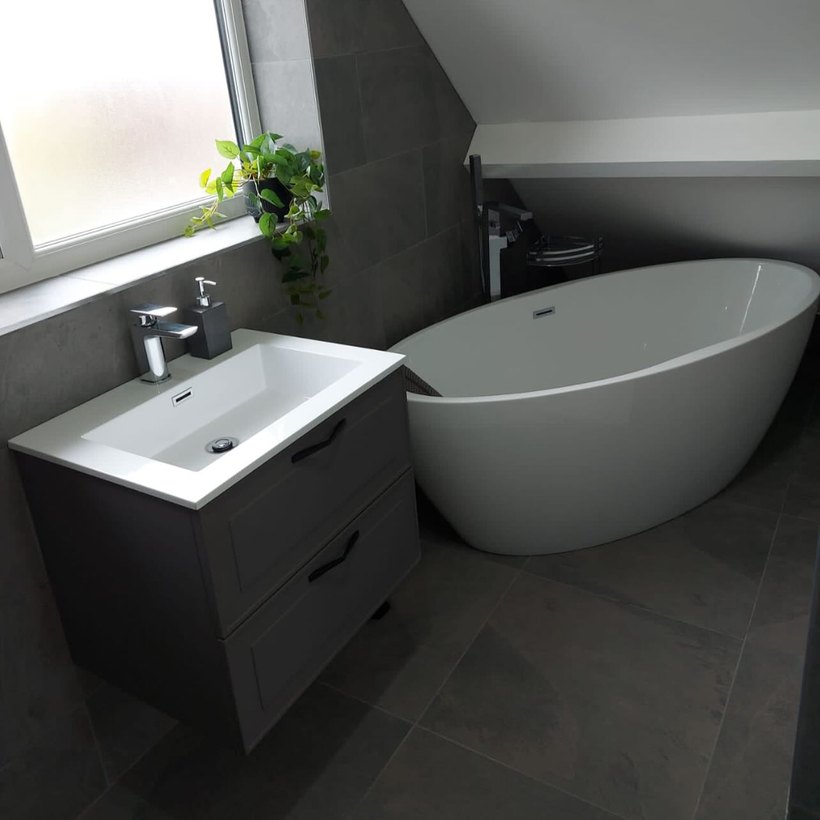 Modern loft bathroom with a freestanding bath and vanity