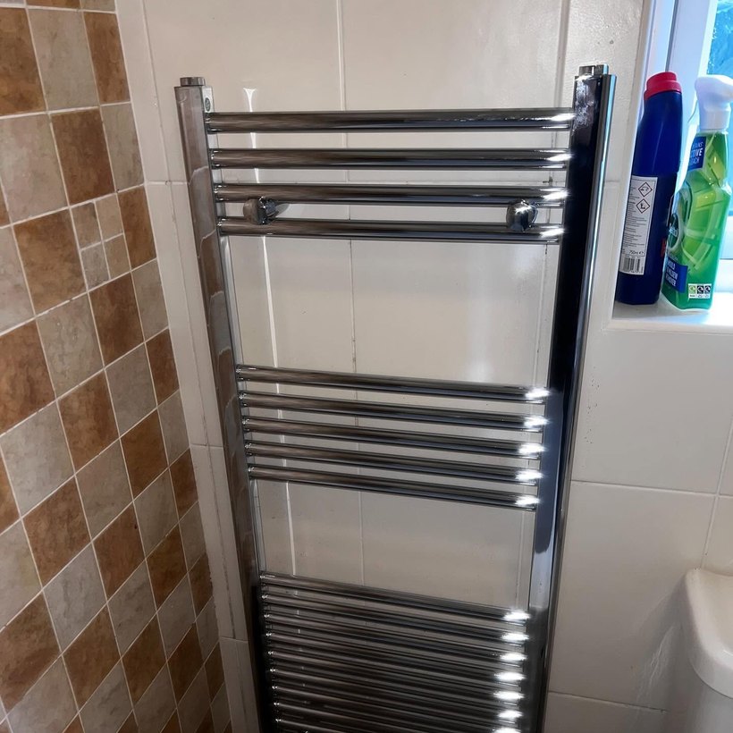 Chrome heated towel radiator fitted in a bathroom