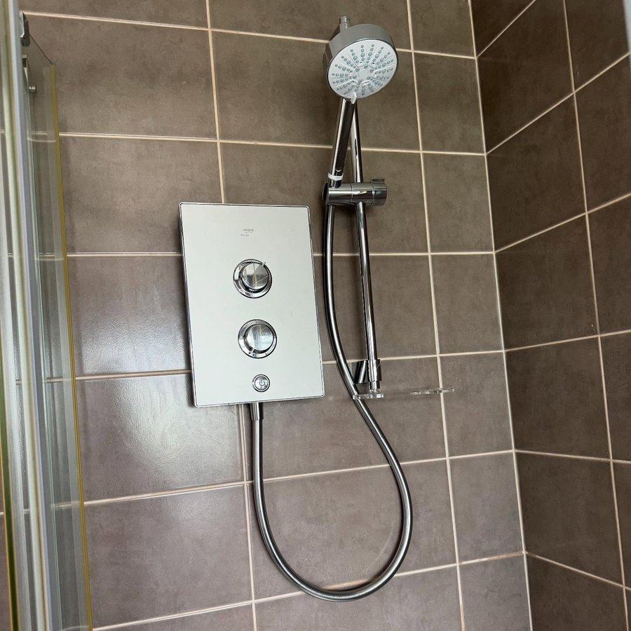 Triton electric shower fitted on a tiled wall